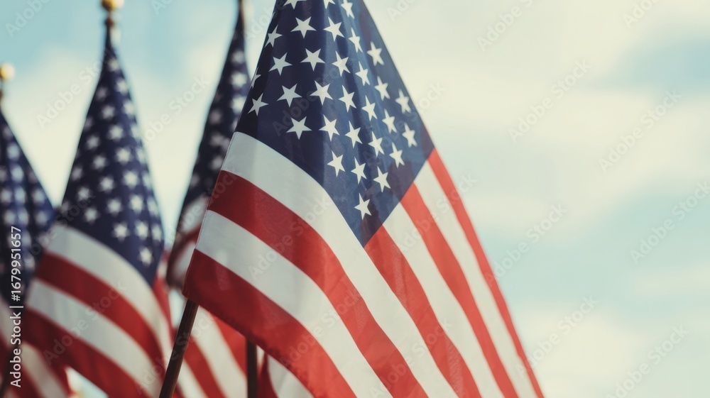 Obraz premium Multiple american flags waving against a cloudy sky, symbolizing patriotism, national pride, and unity, perfect for independence day celebrations
