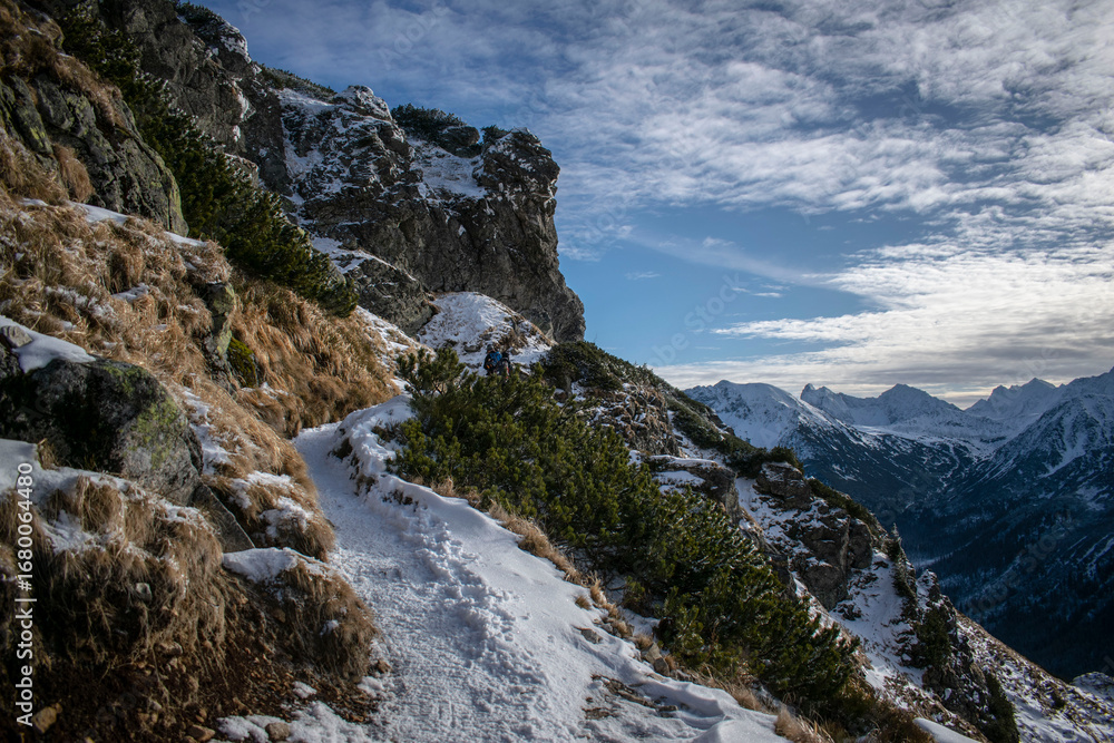 Obraz premium a snow-covered mountain trail with a panorama of the Tatra peaks