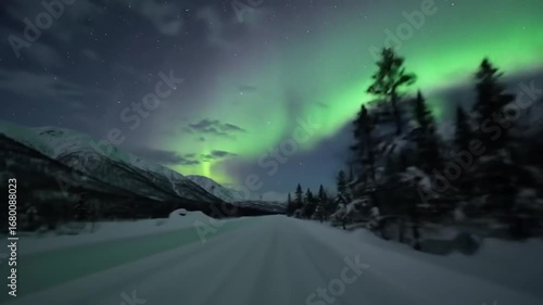 Enchanting Northern Lights Display Over Snowy Mountainous Landscape