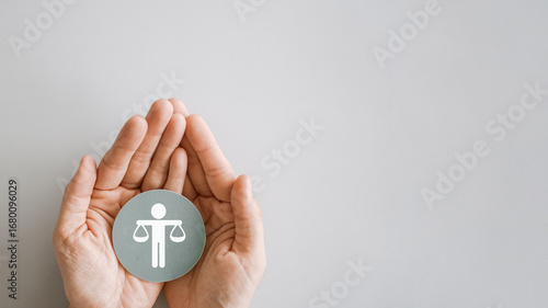 Fotografi Hand holding Human justice scale badge , business ethics and corporate complianc
