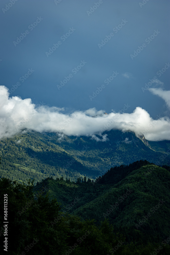 Naklejka premium clouds over the mountains
