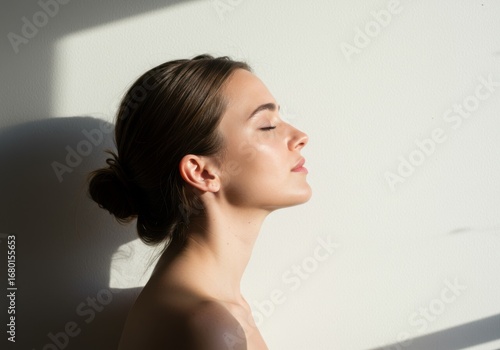 Woman enjoying sunlight embrace peaceful serene moment outdoors natural light and shadows gentle illumination