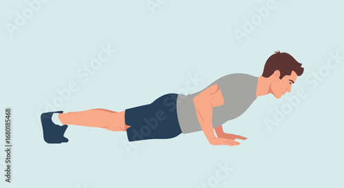 Athletic man in a grey t-shirt and dark shorts performing a push-up exercise on a light blue background, demonstrating fitness and strength training