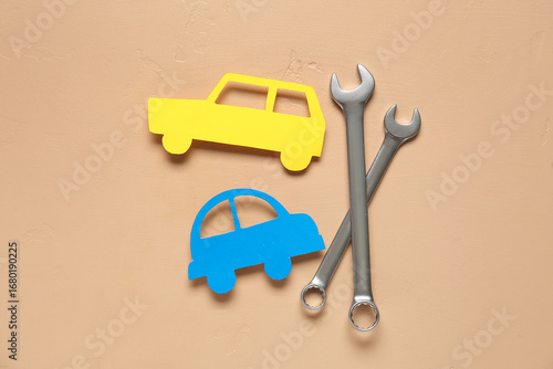 Wrenches and toy car on bei...