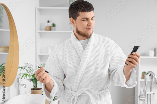 Young man with trimmer and ...