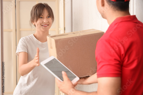 Young woman receiving parce...