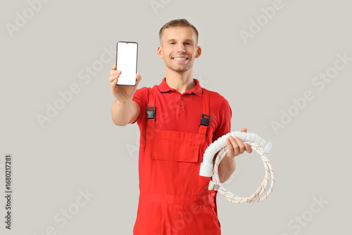 Male plumber with mobile ph...