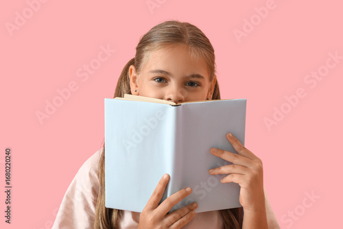 Cute schoolgirl with book o...