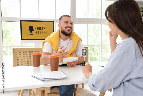 Male podcaster with noteboo...