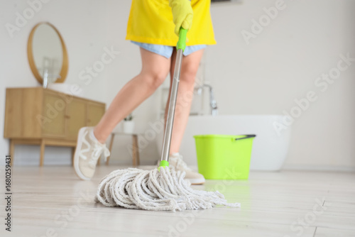 Housewife mopping floor in ...