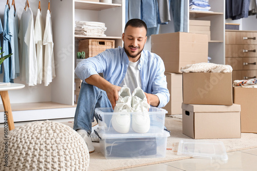 Young man organizing white ...