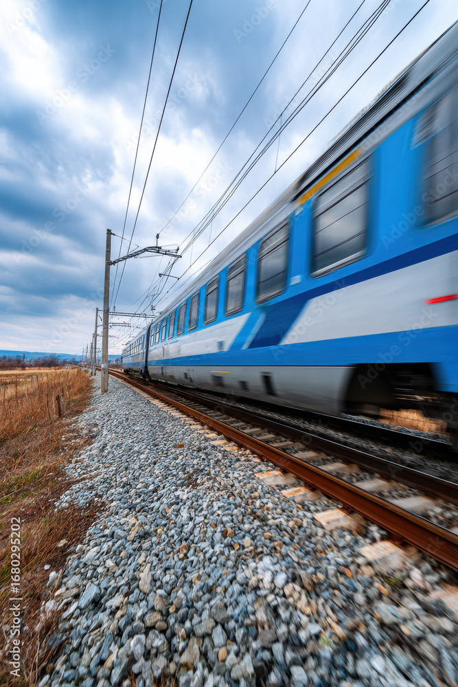 Fototapeta premium A high-speed train passing through countryside fields