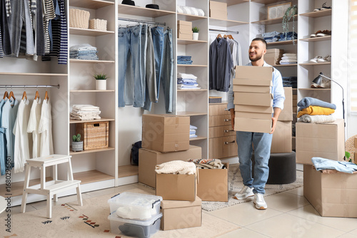Young man with wardrobe box...