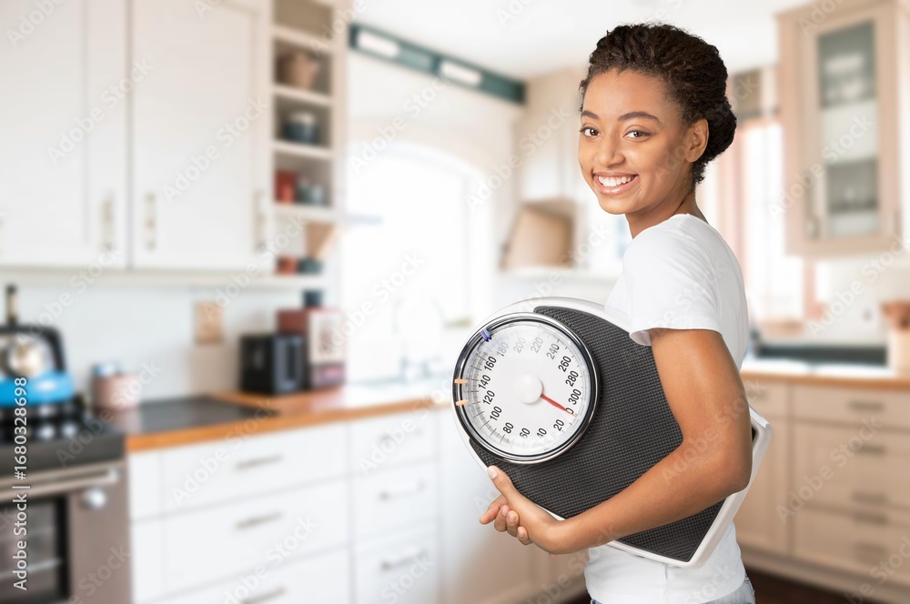 © BillionPhotos.com - Diet and weight loss. Young woman hold floor scale © BillionPhotos.com - Diet and weight loss. Young woman hold floor scale