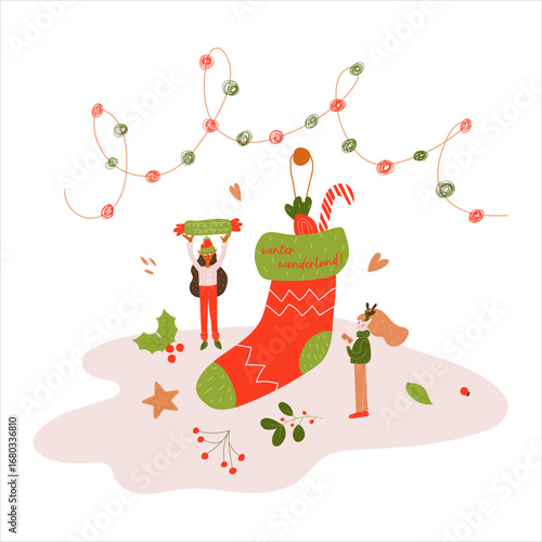 Two miniature elves put candy in a Christmas sock. Winter. New Year. Christmas. 