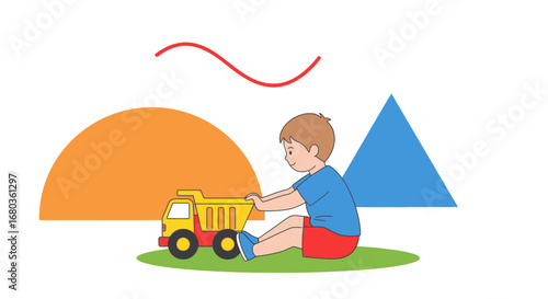 A young boy enjoys playing with a toy truck on a grassy area with colorful shapes