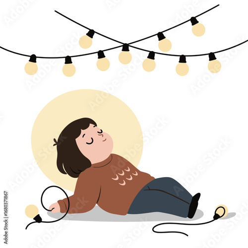 A relaxed child lying down beneath glowing string lights, enjoying the moment.