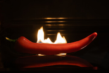 Papier peint photo Piments forts Piment chili devant flamme ardente  © Andrey Nikitin