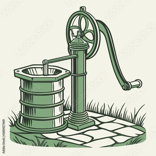Vintage green water well pump with a large wheel and handle situated on a stone patio surrounded by grass