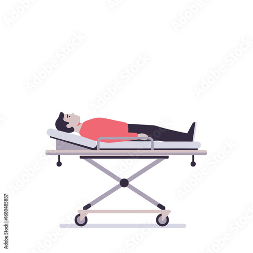 A man lies on a hospital gurney, wearing a red shirt and black pants.