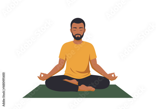 A bearded man sits in a yoga pose on a mat with his eyes closed