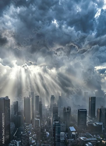 Dramatic city skyline with sun rays piercing storm clouds
