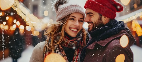 Smiling loving couple walking down the street on a winter night in the city