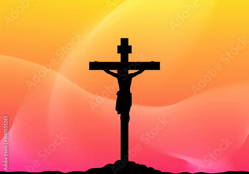 Silhouette of crucifix with Christ against a sunsetcolored background