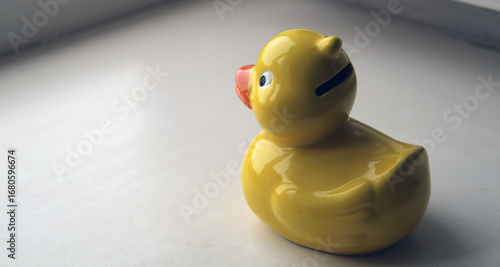 Toy piggy bank - yellow duck. Place for text.