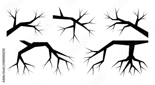 A collection of scary tree branch silhouettes. This abstract vector set of black, spiky shapes is isolated and perfect for Halloween or horror themes.