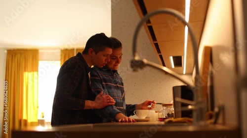 a young couple a playful tea time in their cozy kitchen, filled with love and laughter. They tender interactions as they feed each other, share sweet kisses, and embrace warmly.