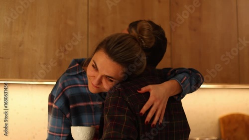 a young couple a playful tea time in their cozy kitchen, filled with love and laughter. They tender interactions as they feed each other, share sweet kisses, and embrace warmly.