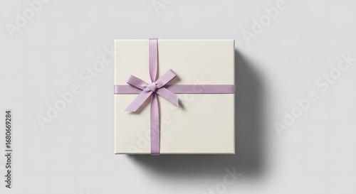 Cream gift box with purple ribbon isolated on white background