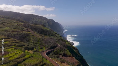 Wallpaper Mural Aerial Drone Shot of Ponta do Tristao Lush Green Cliffs Plunging Into The Atlantic Ocean In Madeira, Portugal on a Sunny Spring Day. Torontodigital.ca