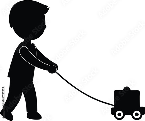 Silhouette of a young boy pulling a toy wagon