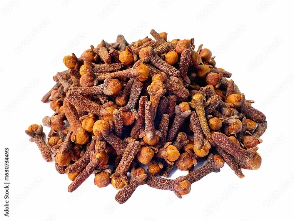 Fototapeta premium A pile of fresh dried brown cloves isolated on white background. Spice cloves. Close up of dried aromatic clove flower buds.