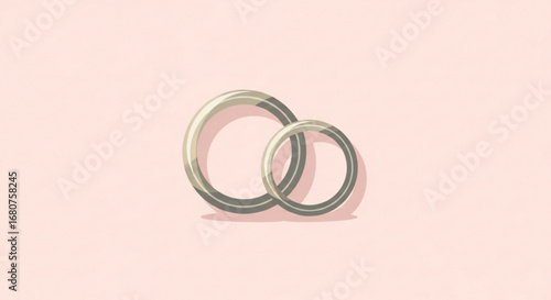 Two wedding rings symbolizing love and commitment on a light pink background, perfect for invitations