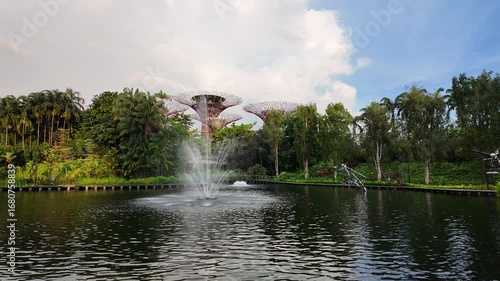 SINGAPORE, SINGAPORE - 27th SEPTEMBER 2024: View across Dragonfly Lake to Supertree Grove in Gardens By The Bay, Singapore.With fountain