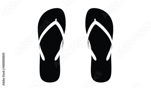 A pair of simple black flip flops with white straps isolated on a clean white background representing summer footwear and casual beach style