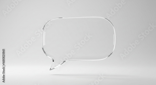 A clear glass speech bubble floating in a white space with soft lighting and subtle shadow effects around it