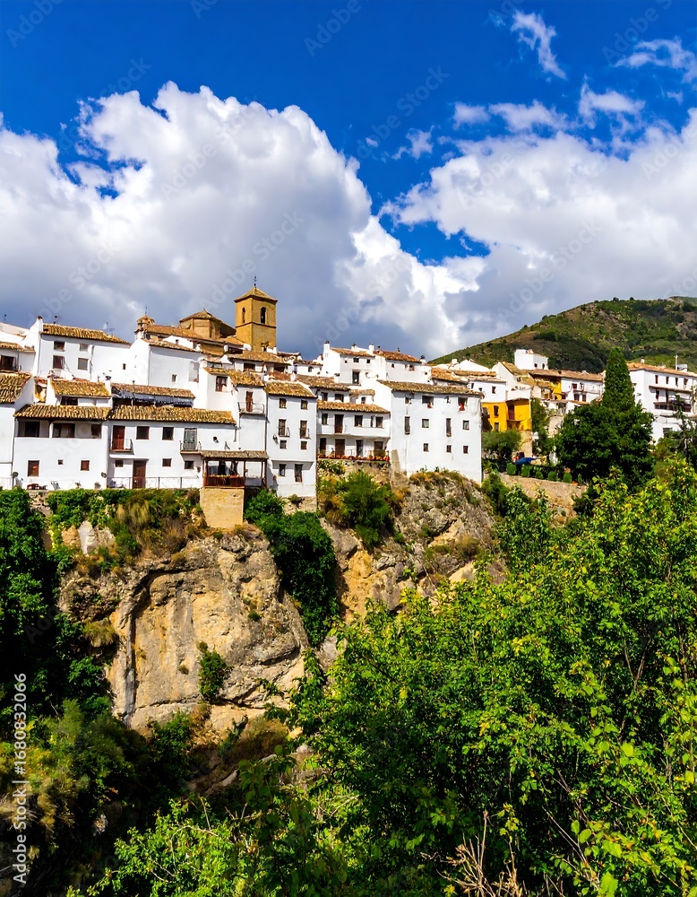 Obraz premium Picturesque mountainside town under a blue sky