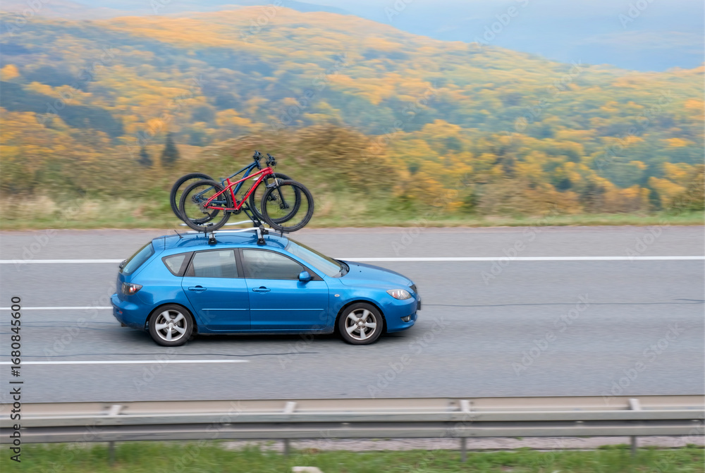 Fototapeta premium Old Japanese Hatchback On Intercity Highway With Bicycles On Roof