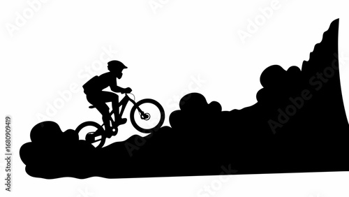 Silhouette of a mountain biker riding up a steep hill with helmet and bike in black and white landscape view