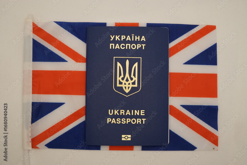 Fototapeta premium ukrainian citizen's passport with the british flag in the background