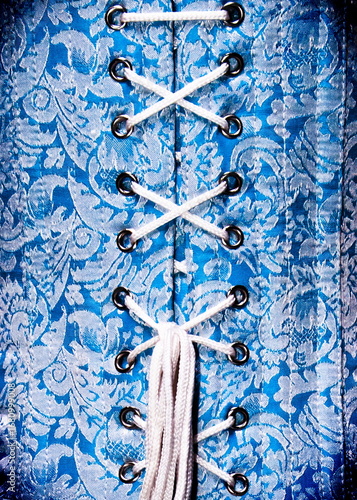 Close-up of a blue corset with white lacing