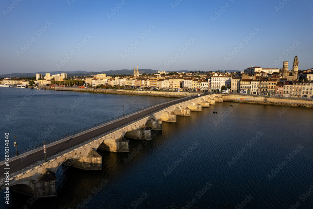 Fototapeta premium Vue aérienne de la ville de Mâcon avec un premier plan le pont Saint-Laurent franchissant la Saône et débouchant sur le quai Lamartine