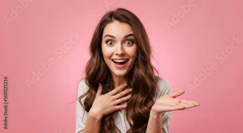 A young woman with a surprised and happy expression, gesturing with open hands against a vibrant pink background.