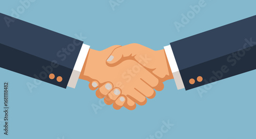 Two business people in suits shaking hands firmly to seal a deal or agreement on a blue background