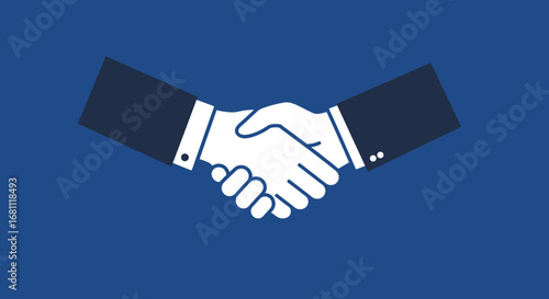 Two business people in suits shaking hands in agreement on a solid blue background representing partnership and trust