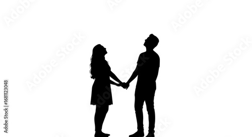 Silhouetted couple holding hands and looking up at the sky against a bright white background